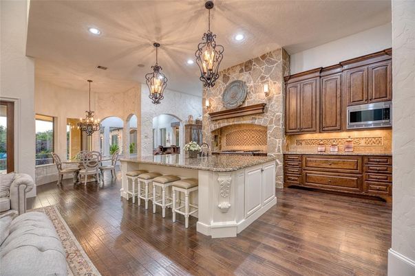 Chandelier, Dining room, Fireplace, Interior, Kitchen, Pendant Lights, Recessed Lighting, Stone Walls, Wood Texture Flooring
