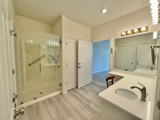 Bathroom, Dual Sink Vanities, Glass Shower, Interior, Recessed Lighting, Wood Texture Flooring
