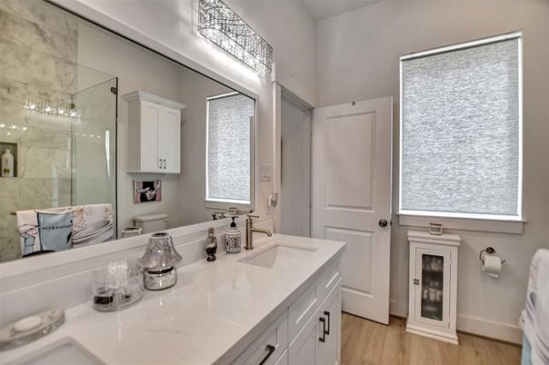 Bathroom, Dual Sink Vanities, Glass Shower, Interior, Marble Walls, Wood Texture Flooring