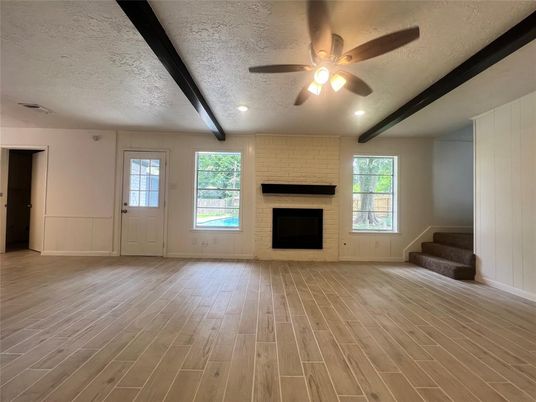 Empty room, Fireplace, Interior, Recessed Lighting, Stone Walls, Wooden Beams, Wood Texture Flooring