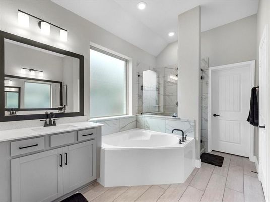 Bathroom, Dual Sink Vanities, Glass Shower, Interior, Marble Walls, Recessed Lighting, Wood Texture Flooring