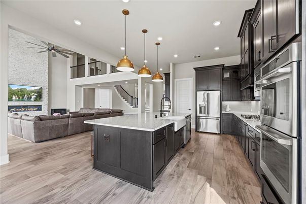 Fireplace, Interior, Kitchen, Living room, Pendant Lights, Recessed Lighting, Stainless Steel Appliances, Wood Texture Flooring