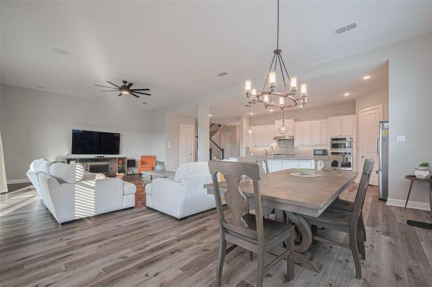 Chandelier, Dining room, Interior, Kitchen, Living room, Pendant Lights, Recessed Lighting, Stainless Steel Appliances, Wood Texture Flooring