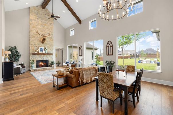 Chandelier, Dining room, Fireplace, Interior, Living room, Recessed Lighting, Stone Walls, Wooden Beams, Wood Texture Flooring