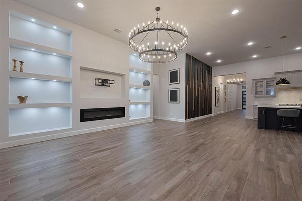 Chandelier, Empty room, Fireplace, Interior, Kitchen, Pendant Lights, Recessed Lighting, Wood Texture Flooring