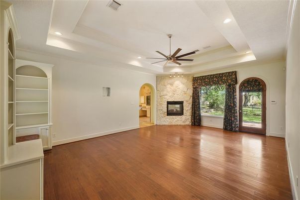 Empty room, Fireplace, Interior, Recessed Lighting, Stone Walls, Wood Texture Flooring