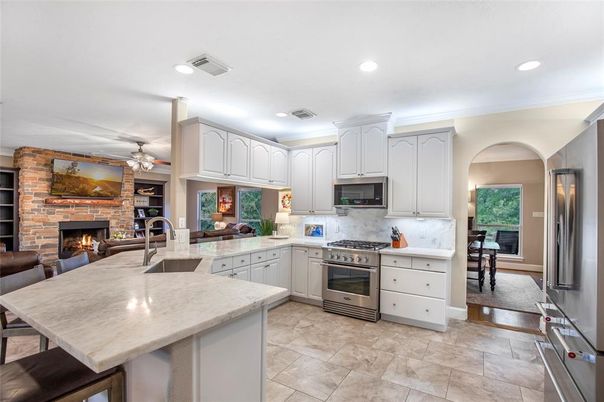 Fireplace, Interior, Kitchen, Recessed Lighting, Stainless Steel Appliances, Stone Walls