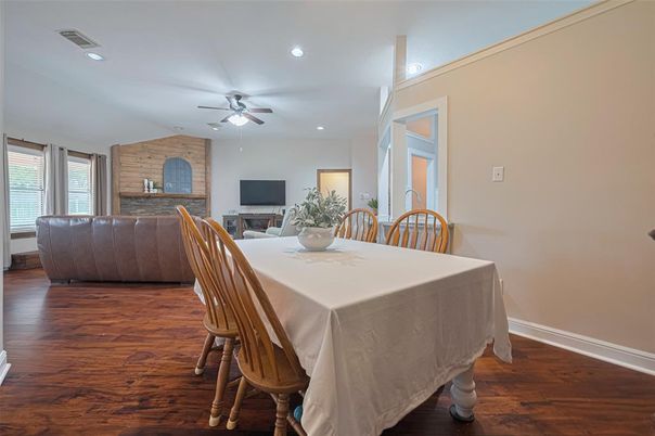 Dining room, Fireplace, Interior, Living room, Recessed Lighting, Stone Walls, Wood Texture Flooring