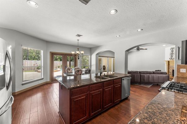 Chandelier, Fireplace, Interior, Kitchen, Recessed Lighting, Wood Texture Flooring