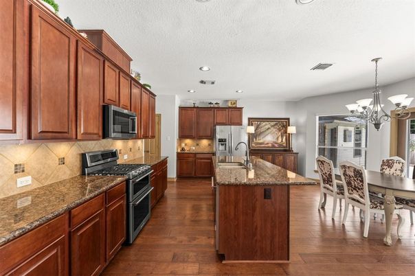 Chandelier, Dining room, Interior, Kitchen, Recessed Lighting, Stainless Steel Appliances, Wood Texture Flooring
