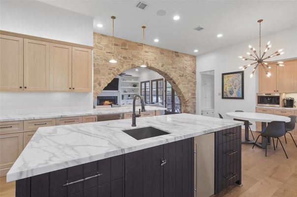 Fireplace, Interior, Kitchen, Pendant Lights, Recessed Lighting, Stainless Steel Appliances, Stone Walls, Wood Texture Flooring