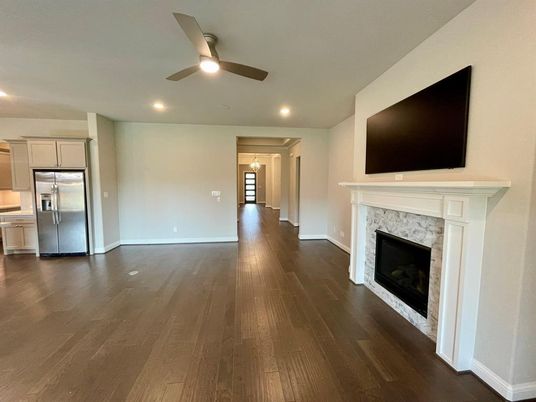Empty room, Fireplace, Interior, Kitchen, Recessed Lighting, Stainless Steel Appliances, Wood Texture Flooring
