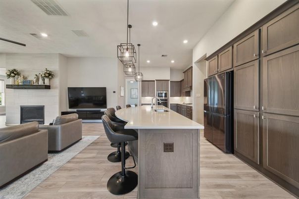 Fireplace, Interior, Kitchen, Living room, Pendant Lights, Recessed Lighting, Stainless Steel Appliances, Wood Texture Flooring