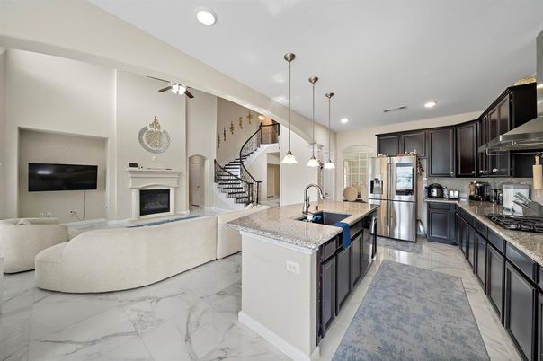Fireplace, Interior, Kitchen, Living room, Marble, Pendant Lights, Recessed Lighting, Stainless Steel Appliances