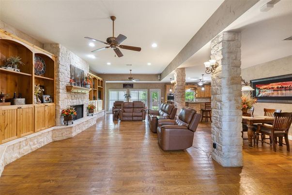 Dining room, Fireplace, Interior, Living room, Recessed Lighting, Stone Walls, Wood Texture Flooring