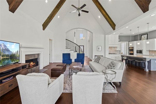 Chandelier, Dining room, Fireplace, Interior, Kitchen, Living room, Pendant Lights, Recessed Lighting, Stainless Steel Appliances, Wooden Beams, Wood Texture Flooring