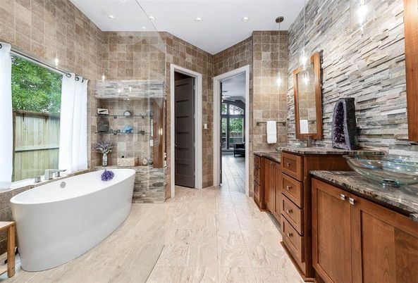 Bathroom, Dual Sink Vanities, Free Standing Baths, Glass Shower, Interior, Recessed Lighting, Stone Walls, Wood Texture Flooring, Wooden Walls