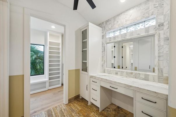 Bathroom, Dual Sink Vanities, Interior, Marble Walls, Recessed Lighting, Wood Texture Flooring