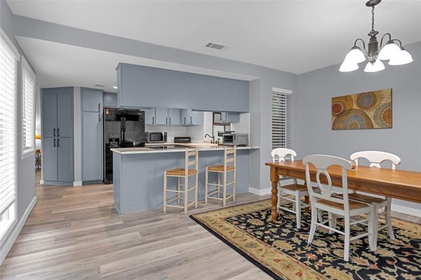 Dining room, Interior, Kitchen, Pendant Lights, Recessed Lighting, Stainless Steel Appliances, Wood Texture Flooring