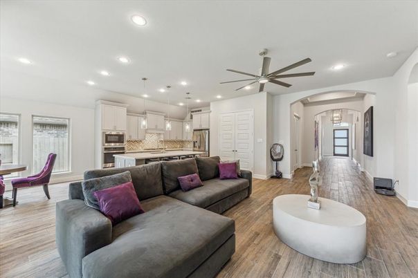 Chandelier, Dining room, Interior, Kitchen, Living room, Pendant Lights, Recessed Lighting, Stainless Steel Appliances, Wood Texture Flooring