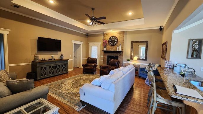 Dining room, Fireplace, Interior, Living room, Recessed Lighting, Stone Walls, Wood Texture Flooring