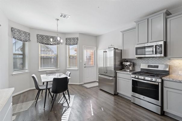 Chandelier, Dining room, Interior, Kitchen, Pendant Lights, Stainless Steel Appliances, Wood Texture Flooring