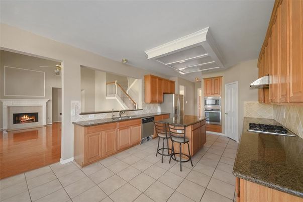Fireplace, Interior, Kitchen, Stainless Steel Appliances, Wood Texture Flooring