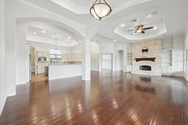 Empty room, Fireplace, Interior, Kitchen, Pendant Lights, Recessed Lighting, Stone Walls, Wood Texture Flooring