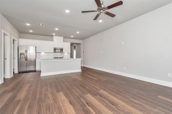 Empty room, Interior, Kitchen, Recessed Lighting, Stainless Steel Appliances, Wood Texture Flooring