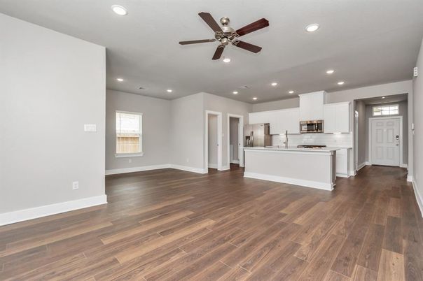 Empty room, Interior, Kitchen, Recessed Lighting, Stainless Steel Appliances, Wood Texture Flooring