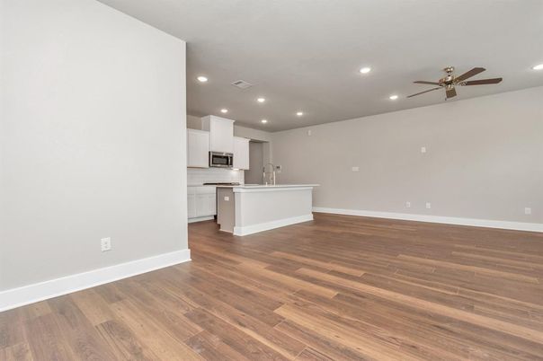 Empty room, Interior, Kitchen, Recessed Lighting, Stainless Steel Appliances, Wood Texture Flooring