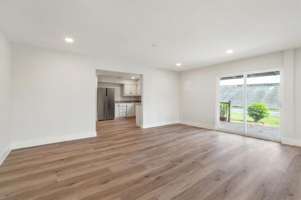 Empty room, Interior, Kitchen, Recessed Lighting, Stainless Steel Appliances, Wood Texture Flooring