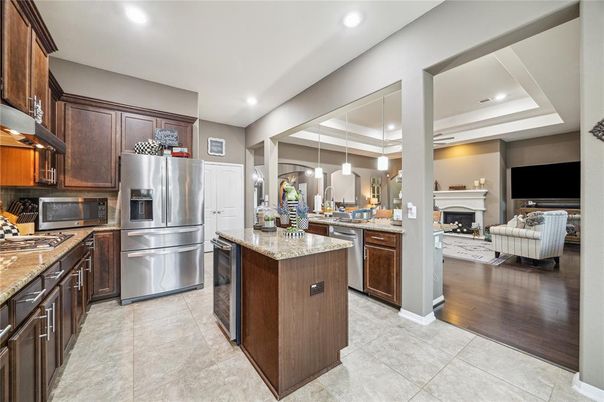 Fireplace, Interior, Kitchen, Living room, Pendant Lights, Recessed Lighting, Stainless Steel Appliances, Wood Texture Flooring