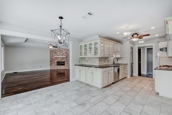 Fireplace, Interior, Kitchen, Pendant Lights, Recessed Lighting, Stainless Steel Appliances, Stone Walls, Wood Texture Flooring