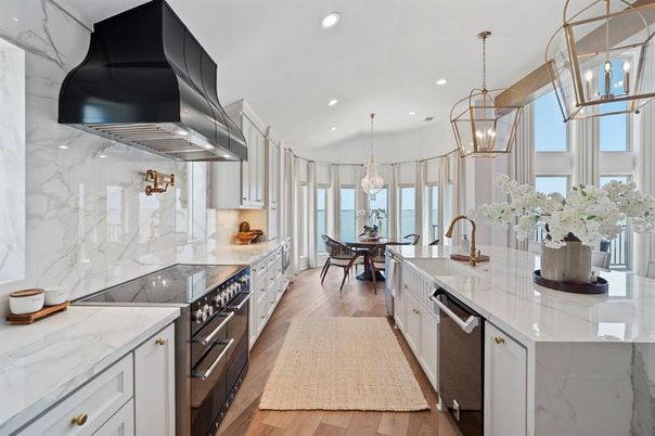 Chandelier, Dining room, Interior, Kitchen, Marble Walls, Pendant Lights, Recessed Lighting, Stainless Steel Appliances, Wood Texture Flooring