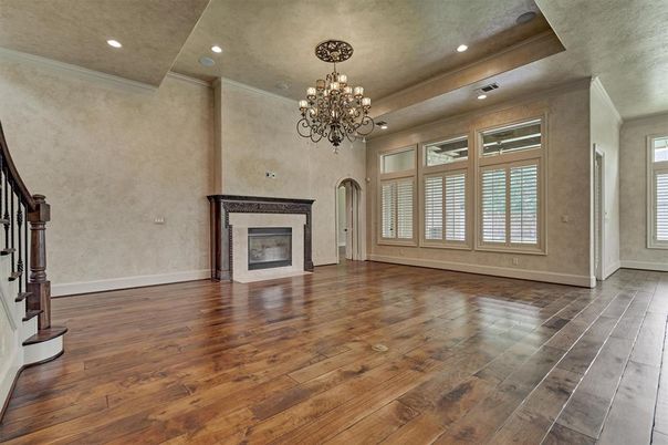 Chandelier, Empty room, Fireplace, Interior, Recessed Lighting, Wood Texture Flooring