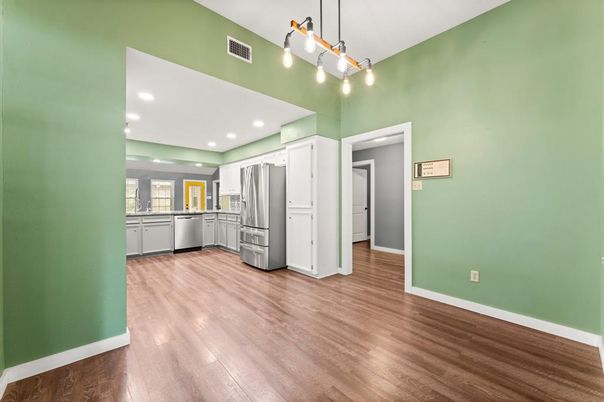 Empty room, Interior, Kitchen, Pendant Lights, Recessed Lighting, Stainless Steel Appliances, Wood Texture Flooring