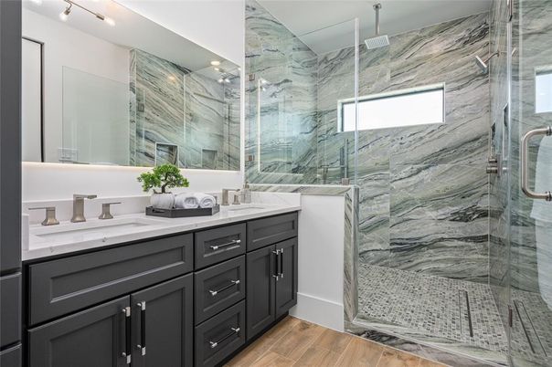 Bathroom, Dual Sink Vanities, Glass Shower, Interior, Marble Walls, Wood Texture Flooring