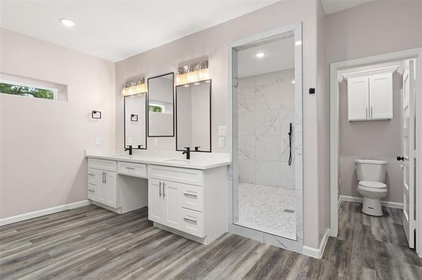 Bathroom, Dual Sink Vanities, Interior, Marble Walls, Recessed Lighting, Wood Texture Flooring
