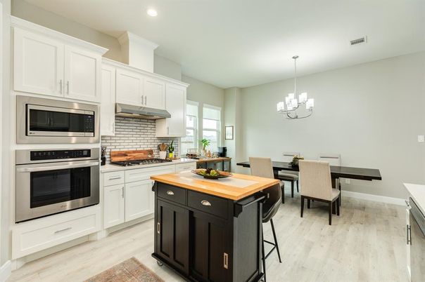 Chandelier, Dining room, Interior, Kitchen, Pendant Lights, Recessed Lighting, Stainless Steel Appliances, Wood Texture Flooring