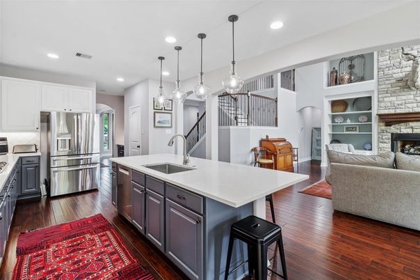 Fireplace, Interior, Kitchen, Pendant Lights, Recessed Lighting, Stainless Steel Appliances, Stone Walls, Wood Texture Flooring