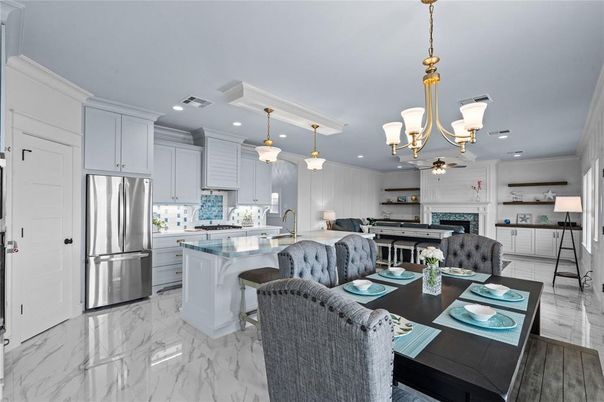 Chandelier, Dining room, Fireplace, Interior, Kitchen, Living room, Marble, Pendant Lights, Recessed Lighting, Stainless Steel Appliances