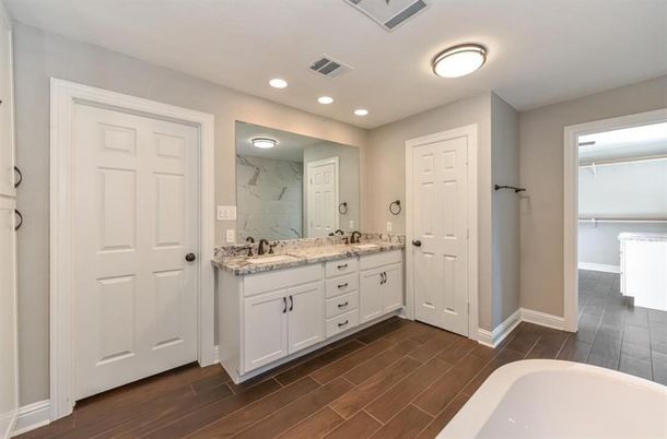 Bathroom, Dual Sink Vanities, Interior, Marble Walls, Recessed Lighting, Wood Texture Flooring