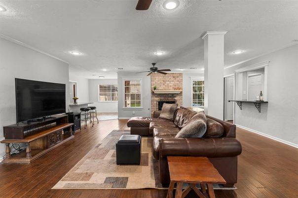 Dining room, Fireplace, Interior, Living room, Recessed Lighting, Stone Walls, Wood Texture Flooring