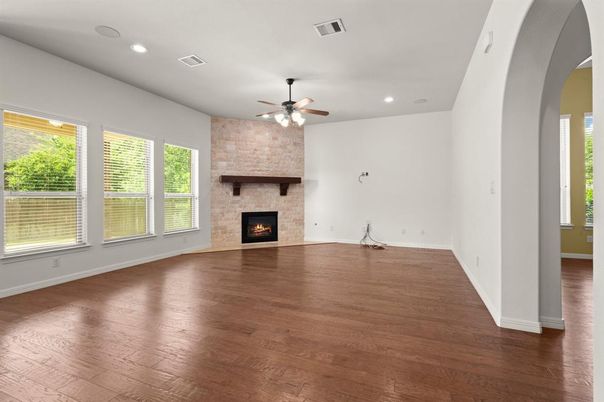 Empty room, Fireplace, Interior, Recessed Lighting, Stone Walls, Wood Texture Flooring