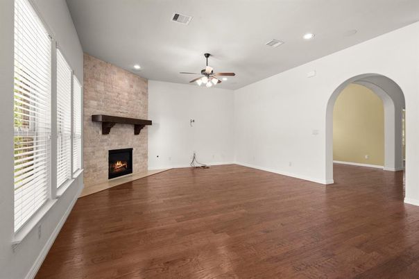 Empty room, Fireplace, Interior, Recessed Lighting, Stone Walls, Wood Texture Flooring
