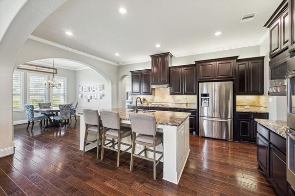 Chandelier, Dining room, Interior, Kitchen, Pendant Lights, Recessed Lighting, Stainless Steel Appliances, Wood Texture Flooring