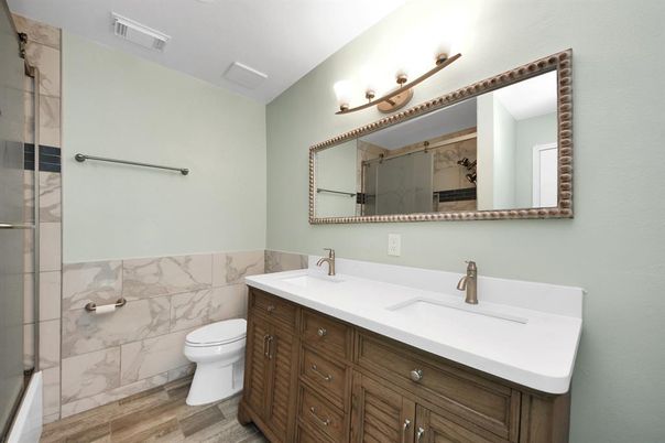 Bathroom, Dual Sink Vanities, Glass Shower, Interior, Marble Walls, Wood Texture Flooring