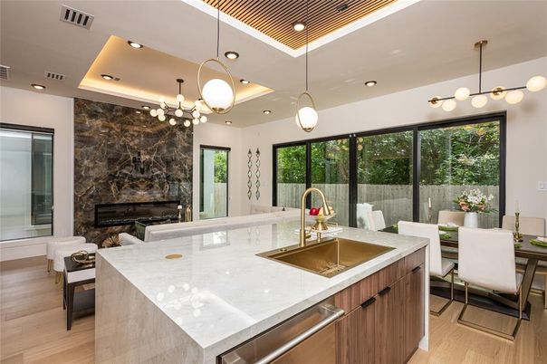 Chandelier, Dining room, Fireplace, Interior, Kitchen, Pendant Lights, Recessed Lighting, Stainless Steel Appliances, Wood Texture Flooring