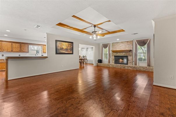 Dining room, Empty room, Fireplace, Interior, Kitchen, Recessed Lighting, Wood Texture Flooring
